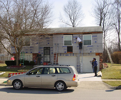 Crew Replacing Siding